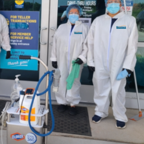 Custodians in protective gear for pandemic cleanin